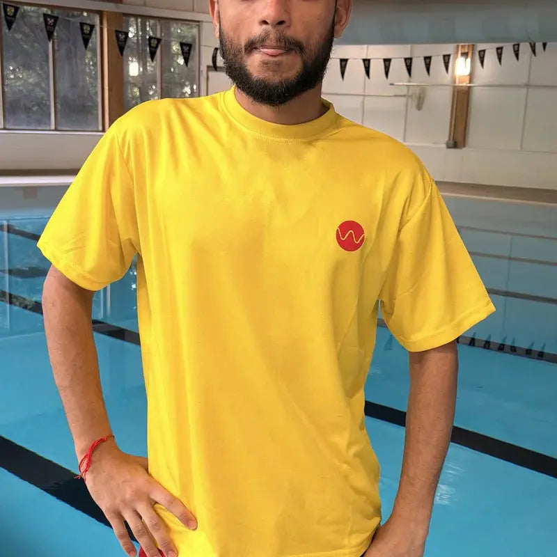 Front of the yellow lifeguard t-shirt with embroidered red Swimcore chest logo