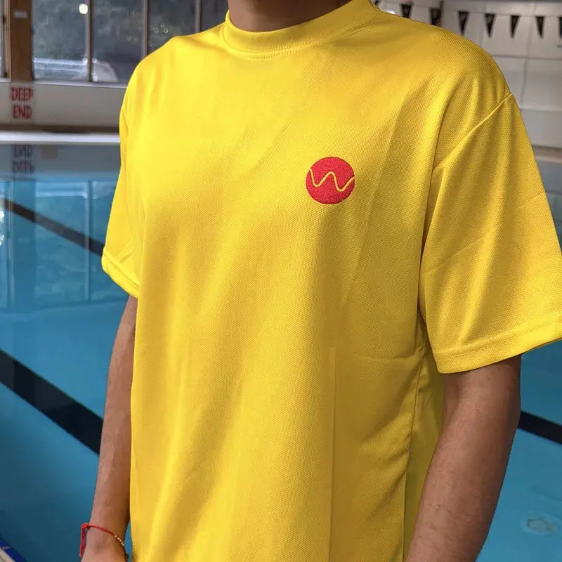 Embroidered red Swimcore wave logo on the chest of the yellow lifeguard t-shirt